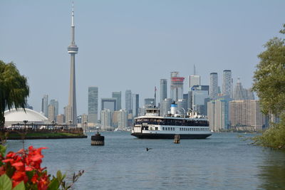 Boats in city against clear sky