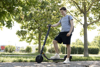 Full length of woman exercising on field