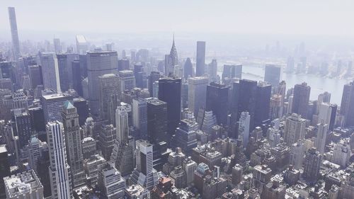 High angle view of modern buildings in manhattan city against sky