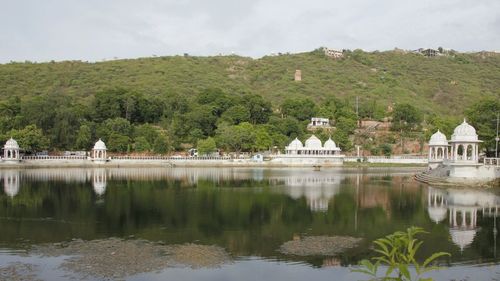 Reflection of trees and buildings in lake