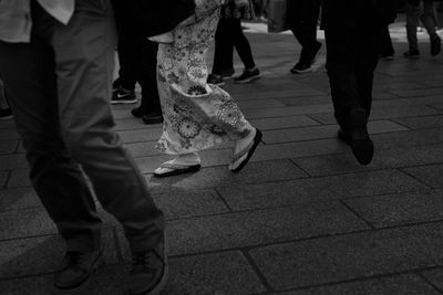 Low section of people walking on footpath