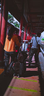 Rear view of people walking in bus