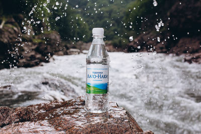 Close-up of water bottle on rock