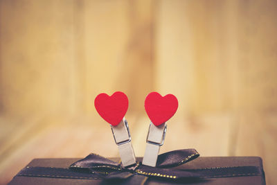Close-up of heart shape clothespins with gift box