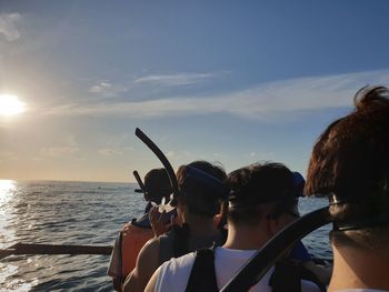 Portrait of people by sea against sky