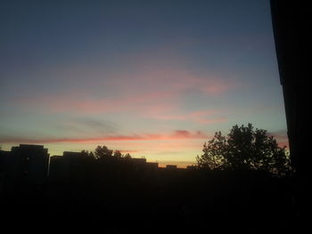 Silhouette of trees against sky at sunset