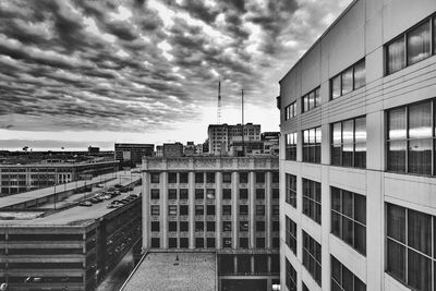 Buildings in city against cloudy sky