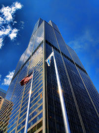 Low angle view of modern building against blue sky