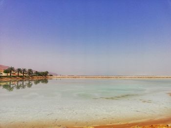 Scenic view of sea against clear blue sky