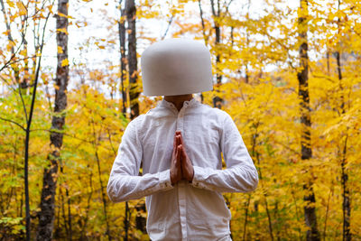 Rear view of man standing in park during autumn