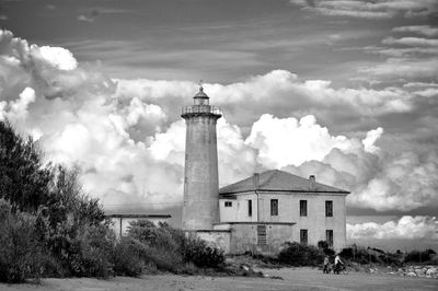 Lighthouse against cloudy sky