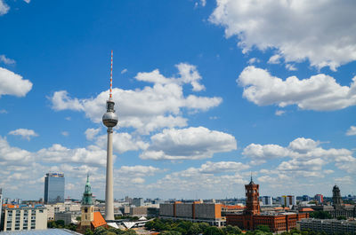 Communications tower against cloudy sky