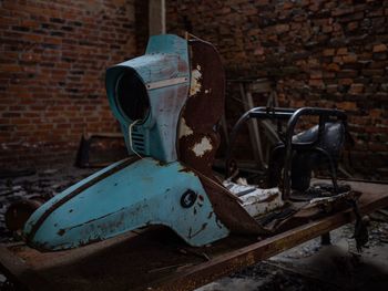 Old rusty wheel against brick wall