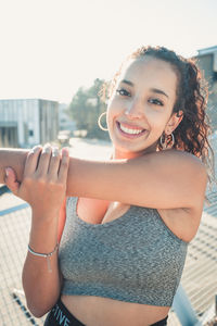 Portrait of smiling young woman holding hands