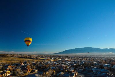 Hot air balloon flying against blue sky