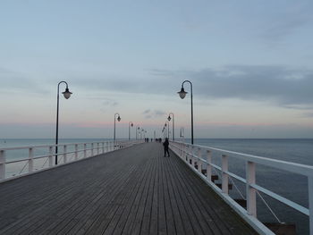 Pier over sea against sky