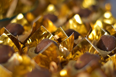 Close-up of chocolates in golden paper