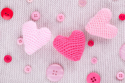 Directly above shot of heart shape on pink fabric