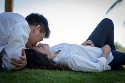 Young couple lying on grass