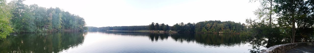 Scenic view of lake in forest against clear sky