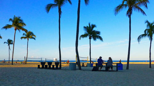 People on beach against sky