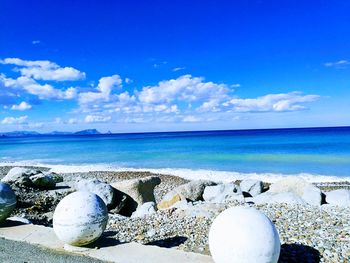 Close-up of sea shore against blue sky