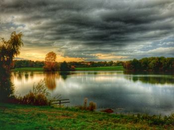 Scenic view of lake against sky during sunset