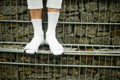 Low section of person standing on railroad track