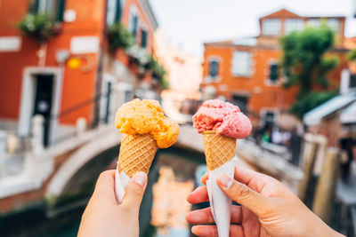 Hands holding ice cream cones