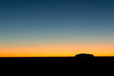 Scenic view of silhouette landscape against clear sky at sunset