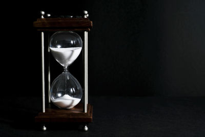 Close-up of clock on table at home