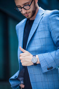 Midsection of a man holding camera