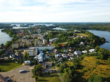 High angle view of buildings by sea against sky