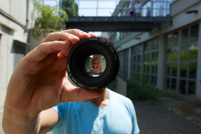 Man on walkway seen through lens