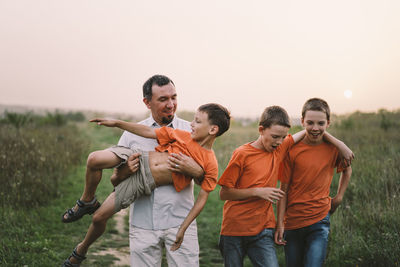 Happy fathers day. father with son are walking in the field.