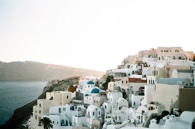 Townscape by sea against clear sky