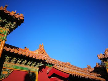 Low angle view of building against clear blue sky