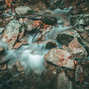 High angle view of stream flowing through rocks