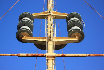 Low angle view of cables against clear blue sky