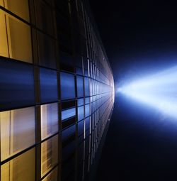 Low angle view of glass building against sky