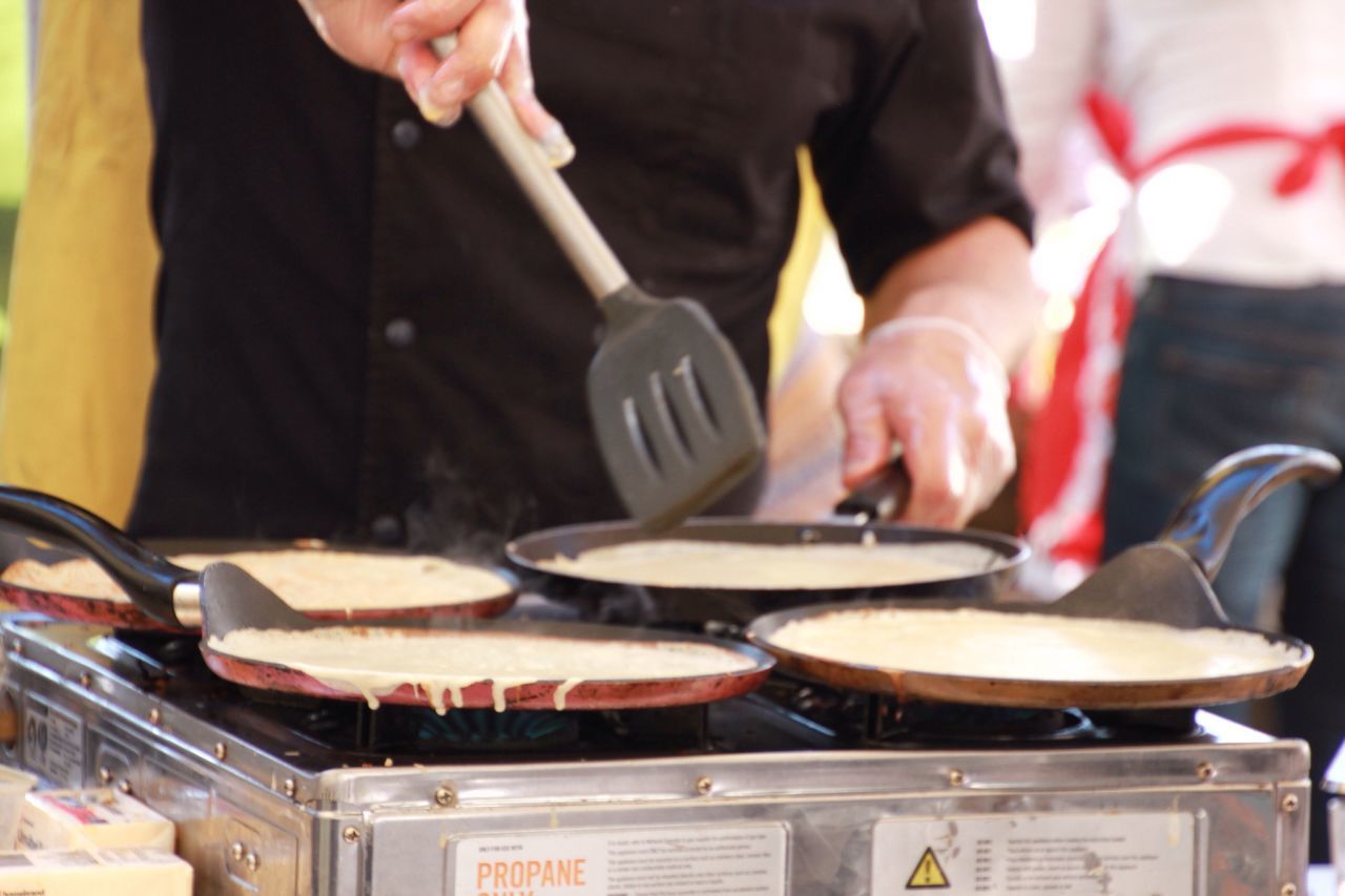 Midsection of man preparing food on stove