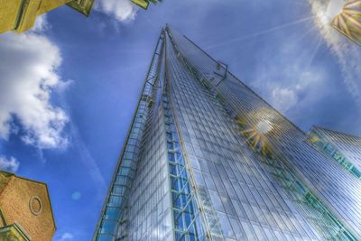 Low angle view of buildings against cloudy sky