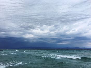 Scenic view of sea against storm clouds