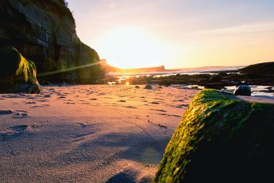 Scenic view of beach against sky during sunset