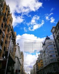 Low angle view of buildings against blue sky