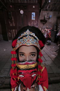 Portrait of young woman in traditional clothing outdoors