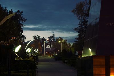 Illuminated street light against sky at night