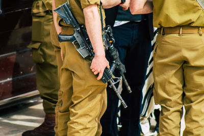 Midsection of army soldiers standing outdoors