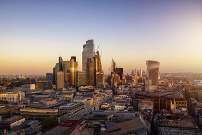 Cityscape against clear sky during sunset