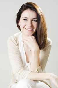 Portrait of young woman against white background